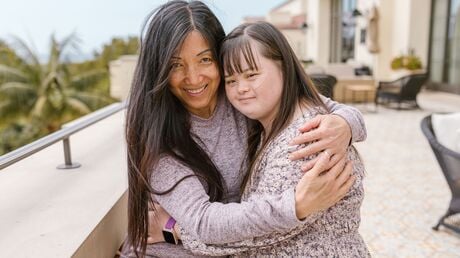 Mother holding an adult child with intellectual and developmental disabilities