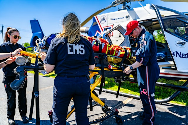 An EMS team preparing a stretcher near a medical helicopter